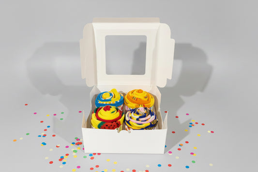 White box with food themed sock cupcakes on a gray background