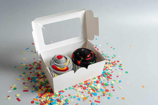 cupcake socks  in a white box on a wooden surface